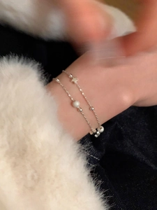 Detail of S925 silver double-layered star bracelet with frosted beads and fine chain