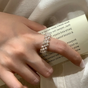 Handcrafted S925 sterling silver beaded ring with woven strap design on model hand