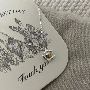 Close-up of S925 sterling silver sunflower necklace with a golden smiley face pendant
