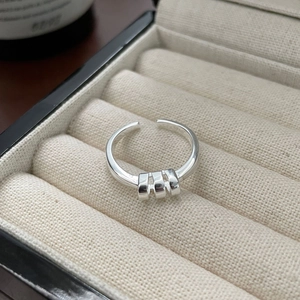 Detail of S925 sterling silver ring with three moving loops in a velvet box