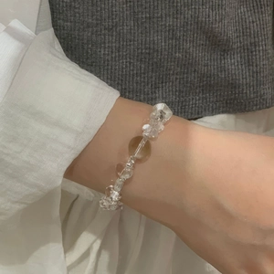 Detailed shot of S925 silver beaded bracelet with clear and amber crystals on wrist