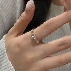 Minimalist S925 sterling silver ring with three movable beads on a model's finger