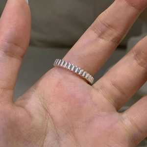 Macro shot of minimalist S925 sterling silver ring with textured vertical stripe finish