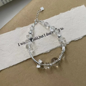 Detail of S925 sterling silver beaded bracelet with clear crystal and bow charm pendant