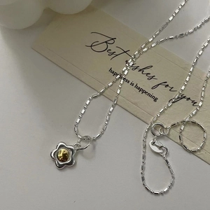 Detail of S925 sterling silver beaded necklace with bicolor flower pendant and S925 hallmark