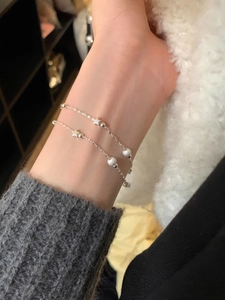 Close-up of double-layer silver star bracelet with frosted beads and polished spheres