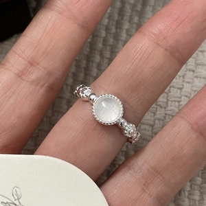 Macro dell'anello in argento S925 con gemma bianca rotonda e dettagli testurizzati