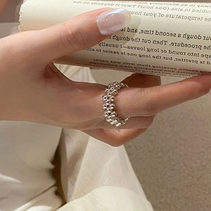 Close-up of S925 sterling silver beaded ring with hand-woven watchband texture