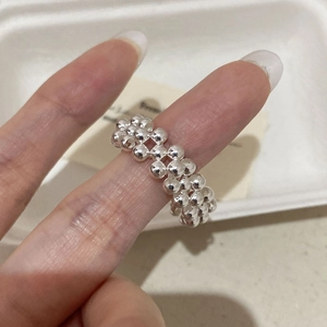 Macro shot of S925 sterling silver woven beaded ring with unique wave texture