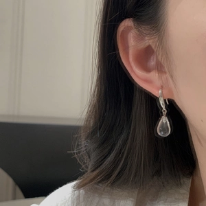 Close-up of elegant S925 sterling silver water drop earring with clear crystal pendant