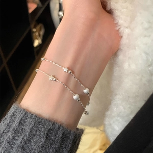 Minimalist double-layer S925 silver star bracelet with frosted beads on a female wrist