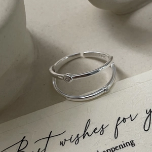 Detail of S925 sterling silver stamp on minimalist double-layered zircon ring band