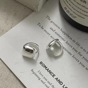 Detail of square S925 sterling silver hoop earrings on artistic poetry card background
