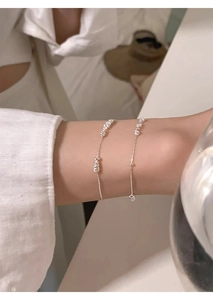 Detailed close-up of a minimalist S925 sterling silver bead bracelet on a woman wrist