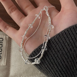 Detail view of double-layered S925 silver beaded bracelet with clear crystal beads and lobster clasp