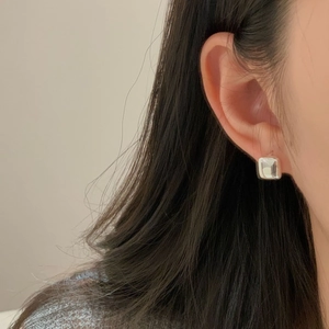 Minimalist S925 sterling silver square huggie hoop earrings worn by a model