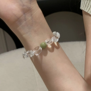 Detail of s925 silver beaded bracelet with clear crystal drops and green agate accent