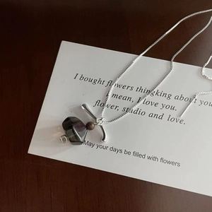 Detailed close-up of S925 silver necklace with smoky quartz pendant on an art card