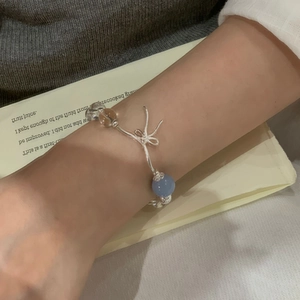 Detail of S925 silver beaded bracelet featuring a butterfly charm and aquamarine beads