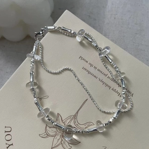 Detail of S925 silver double-layered beaded bracelet with clear crystal accents