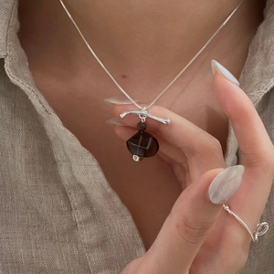 Macro shot of S925 silver necklace with geometric smoky quartz and minimal silver ring