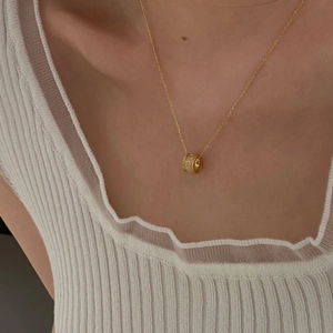 Elegant gold S925 sterling silver star necklace with round barrel pendant on female model