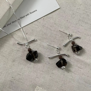Detail of S925 silver necklace and earrings set with smoky quartz and wood beads