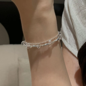 Detail of double-layer S925 silver beaded bracelet with clear crystal beads on wrist