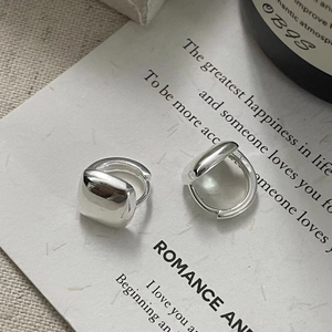 Minimalist square S925 sterling silver hoop earrings with polished finish on beige paper