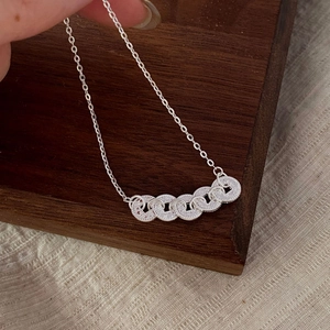Detailed macro view of S925 sterling silver chain with five textured interlocking rings