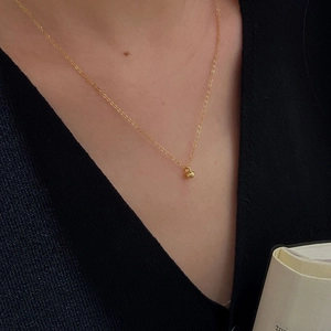 Minimalist S925 sterling silver gold bean necklace for women on elegant black knitwear