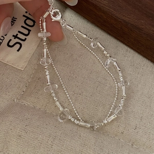 Detail of S925 sterling silver double-layered beaded bracelet with clear crystal accents