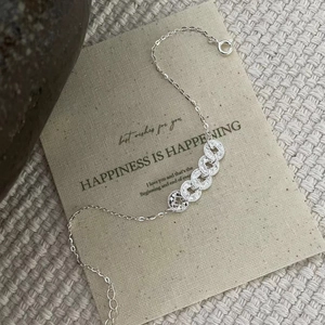 Close-up of interlocking silver coin links and intricate knurled edges on a stylish bracelet