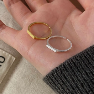 Close-up of minimalist geometric bar rings showing matte finish and S925 engraved stamp