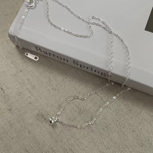 Close-up of S925 sterling silver bean necklace with hallmark on minimalist chain