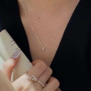 Detailed view of S925 sterling silver ball pendant necklace and irregular wrap ring
