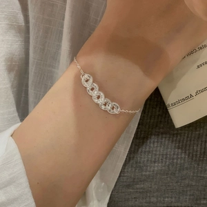 Detailed view of S925 sterling silver bracelet featuring interlocking carved coin rings