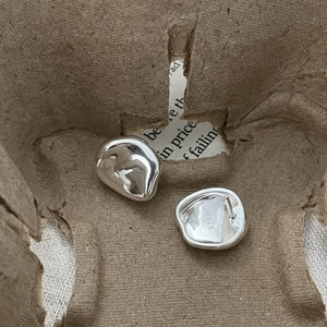Detail shot of irregular organic 925 sterling silver studs with S925 hallmark engraving
