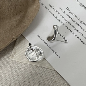 Macro shot of S925 sterling silver irregular stud earrings with detailed hallmark stamp