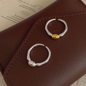 Detail view of S925 sterling silver minimalist rings featuring silver and gold contrast