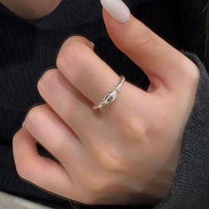 Close-up of S925 sterling silver irregular bean ring worn on a finger