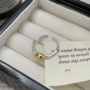 Detailed macro shot of a two-tone S925 sterling silver ring in a velvet box