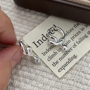 Macro shot of S925 sterling silver twisted drop earrings with clear cubic zirconia stone