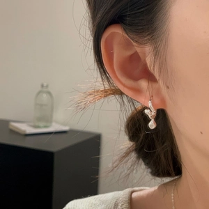 Close-up of S925 sterling silver twisted ear cuffs with liquid metal flowing design