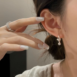 Detailed view of S925 sterling silver twisted drop earrings and woven textured ring