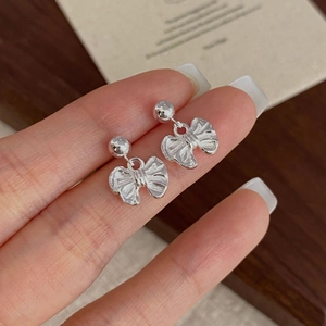 Elegant S925 sterling silver bow earrings with vintage textured metal finish for women