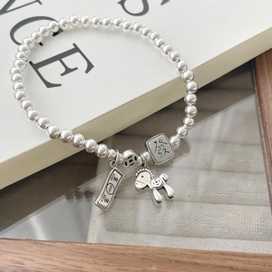 Elegant S925 sterling silver beaded bracelet with money charms on white display