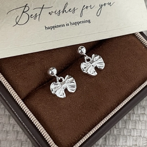 Polished S925 sterling silver bow knot stud earrings in a luxury velvet jewelry box