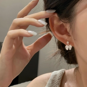 Close-up of elegant S925 sterling silver butterfly stud earring on a model's ear