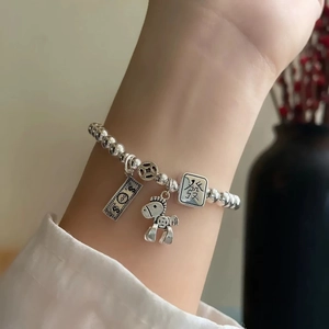 S925 Sterling Silver Beaded Bracelet with Mahjong and Horse Charms on a woman's wrist